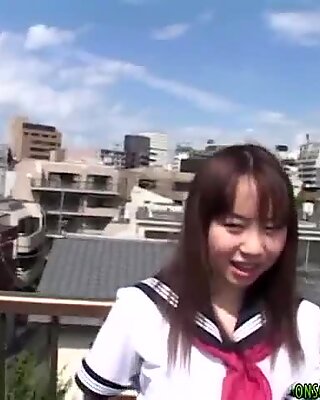 Asian teen poses outdoors before masturbating